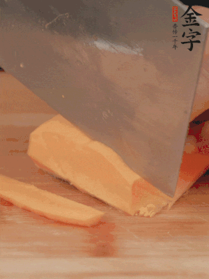 南瓜改刀切片，把蒸好的火腿鋪到南瓜上。